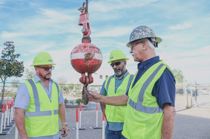 Pictured: Inspectors inspecting a mobile crane hook